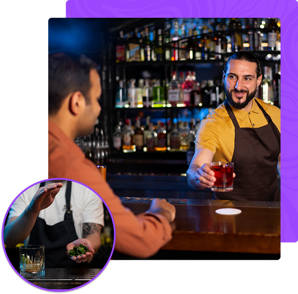 A man sitting at a bar talking to a bartender