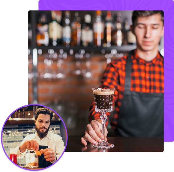 A bartender is preparing a drink in a glass at a bar.