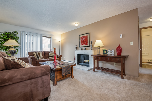 Photo of a living room, showing furniture and a fireplace