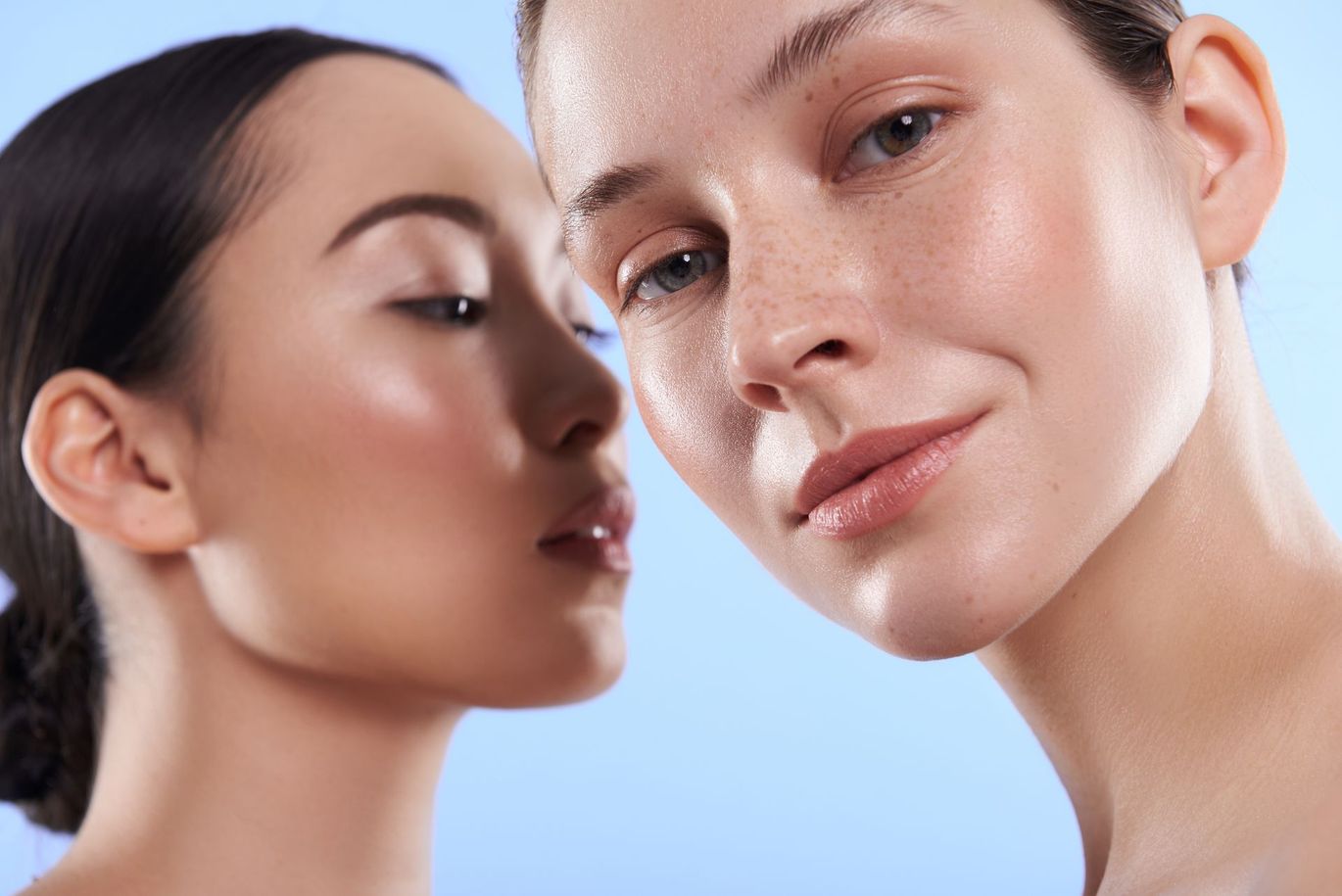 Two women are standing next to each other and looking at the camera.