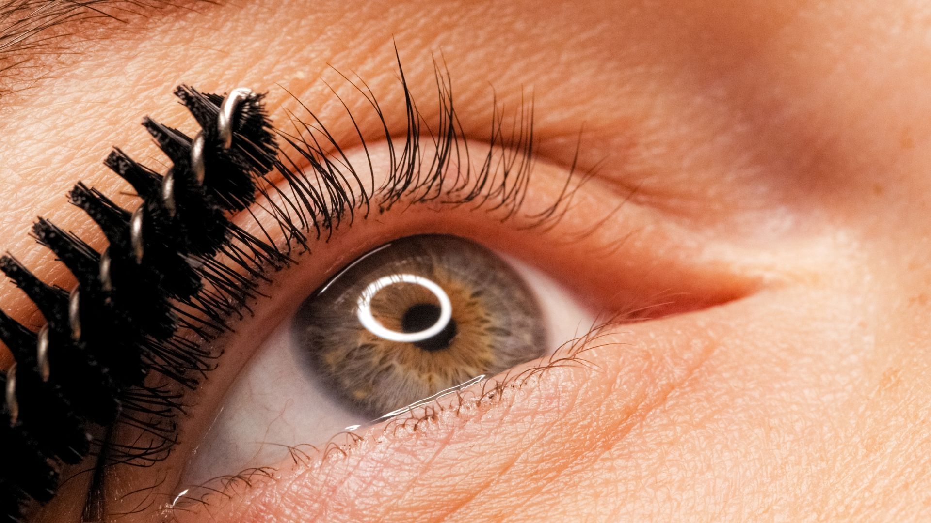 A close up of a woman 's eye with mascara on it.