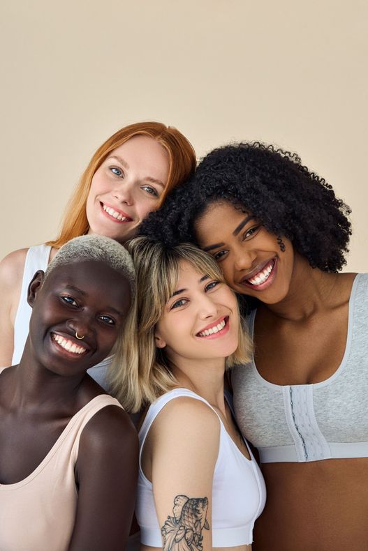 A group of women are posing for a picture together and smiling.