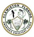 Seal of Clewiston, Florida: black bird, map, trees, sugar mill, and text on a circular design.
