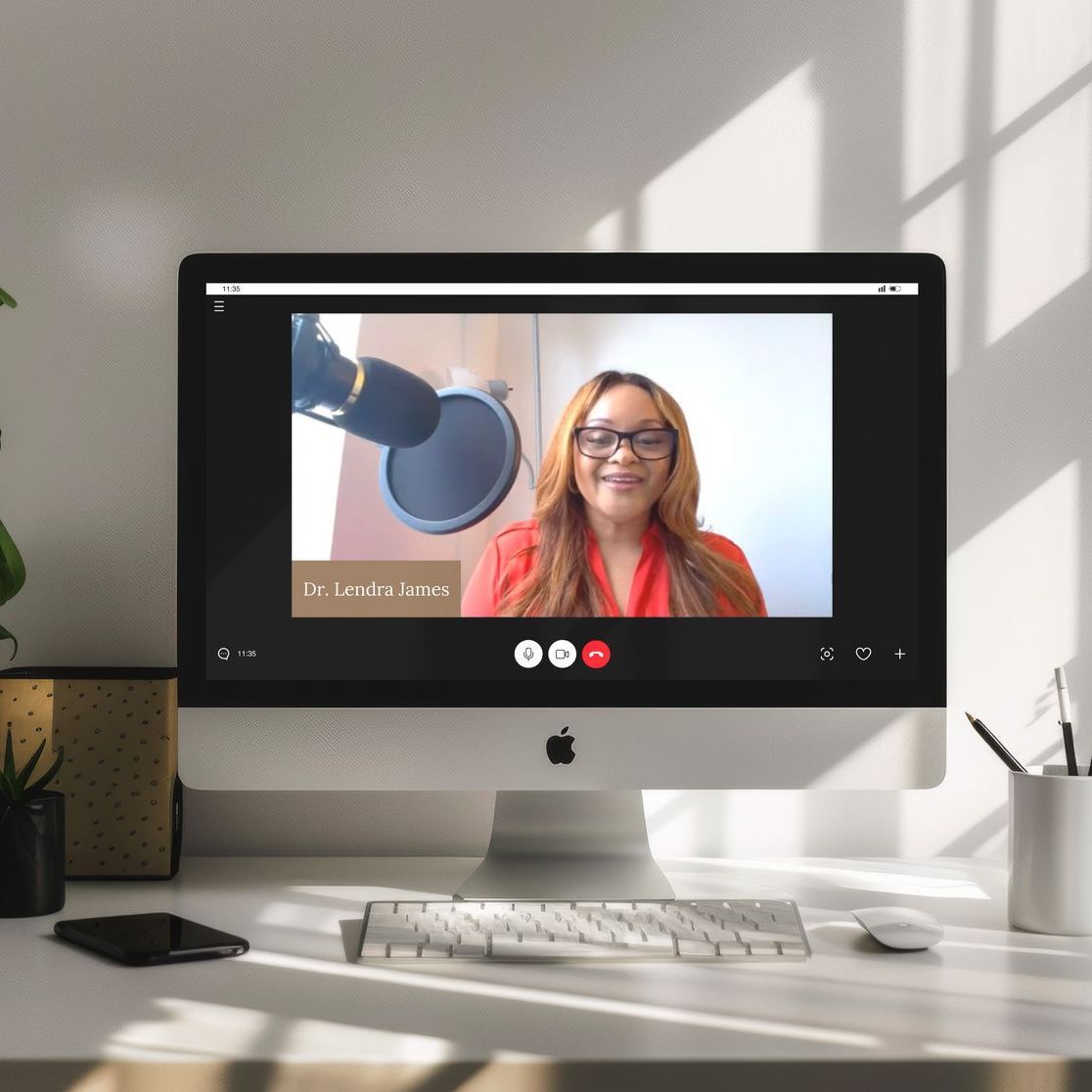 A computer monitor shows a woman talking into a microphone