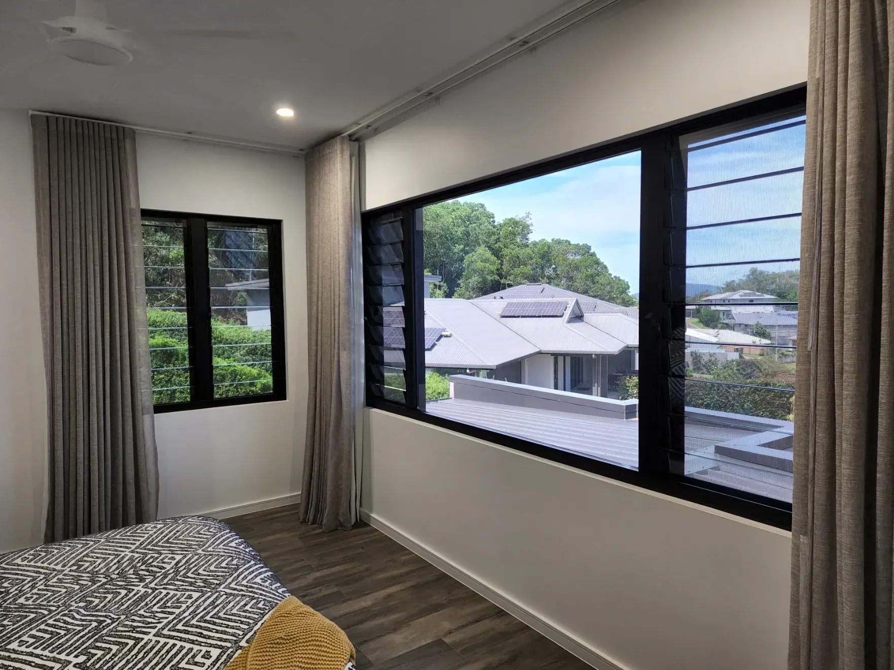 A Bedroom With a Large Window and a Bed — Ace Tinting in Mareeba, QLD