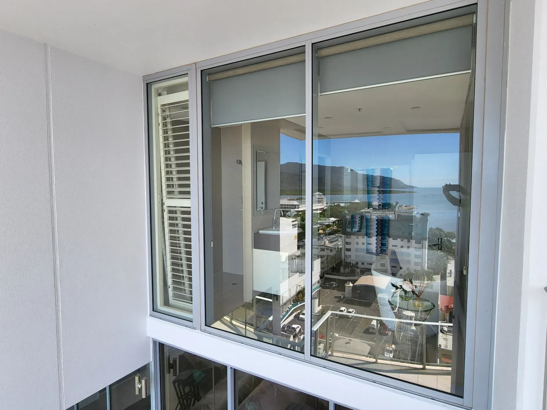A Large Window in a Building With a View of the Ocean — Ace Tinting in Mareeba, QLD