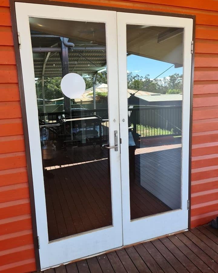 A Pair of Sliding Glass Doors Leading to a Deck — Ace Tinting In Port Douglas, QLD