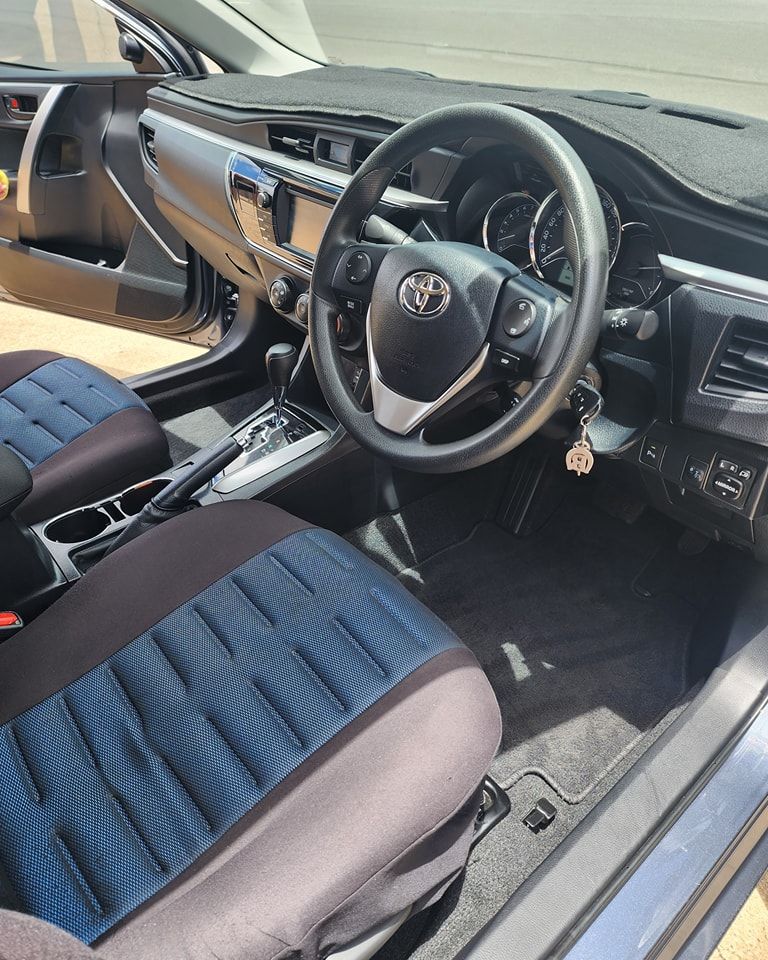 The Inside of a Car With the Door Open and the Steering Wheel Visible — Ace Tinting in Mareeba, QLD