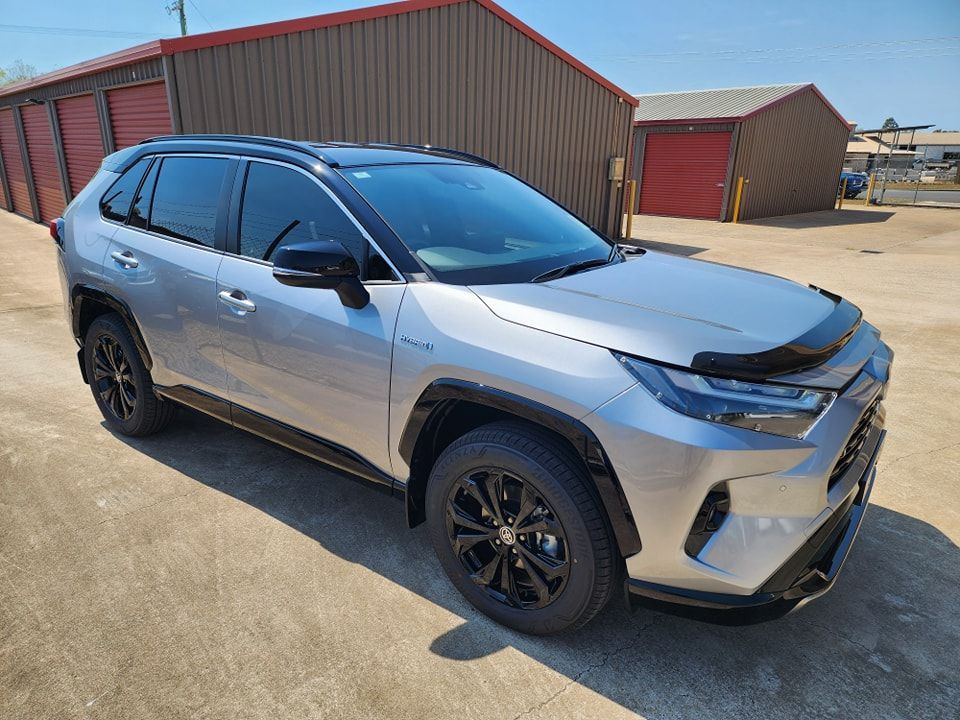 A Silver Toyota RAV4 is Parked in Front of a Storage Building — Ace Tinting in Mareeba, QLD