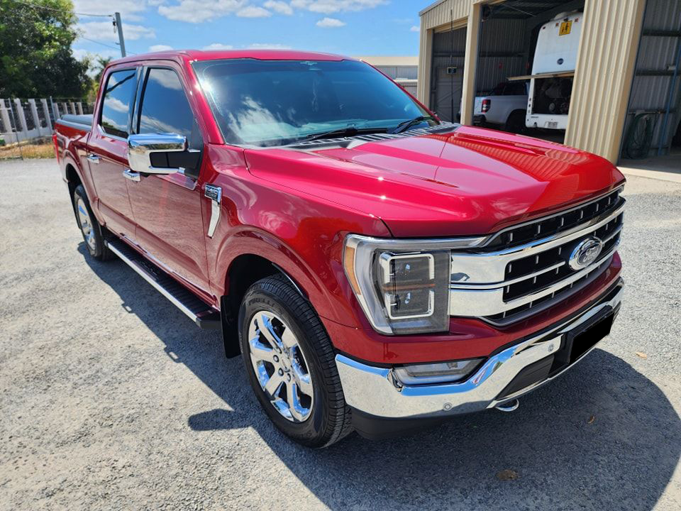 A Red Ford Truck Is Parked In Front Of A Garage — Ace Tinting in Mareeba, QLD