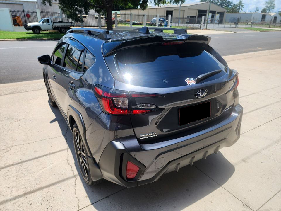 A Black Subaru Outback is Parked on the Side of the Road — Ace Tinting in Mareeba, QLD