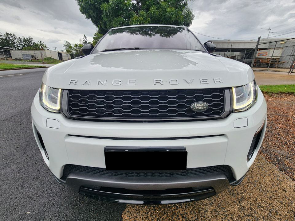 A White Range Rover is Parked on the Side of the Road — Ace Tinting in Mareeba, QLD