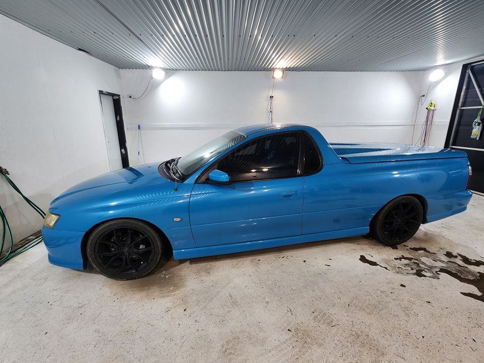 A blue pickup truck is parked in a garage — Ace Tinting in Mareeba, QLD