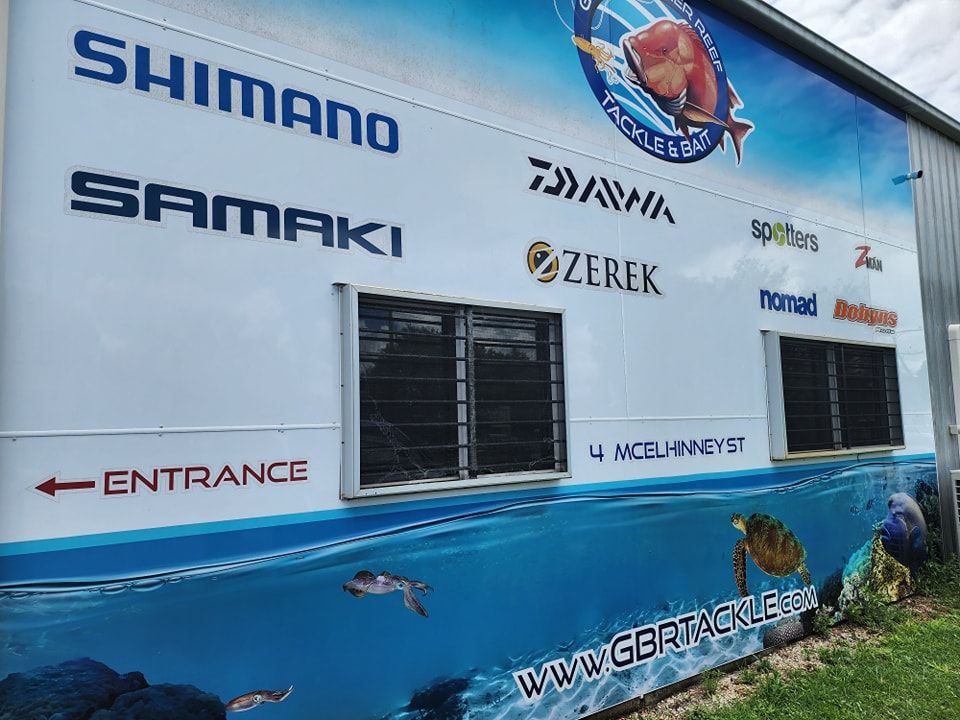 A large billboard on the side of a building advertising fishing gear — Ace Tinting in Mareeba, QLD