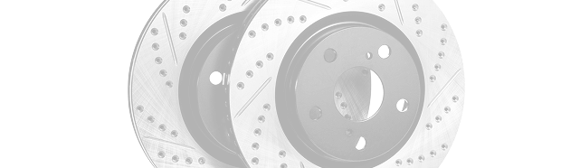 Stacked gray and white circular disc brakes with perforated surfaces on a light background | Integrated Automotive Services