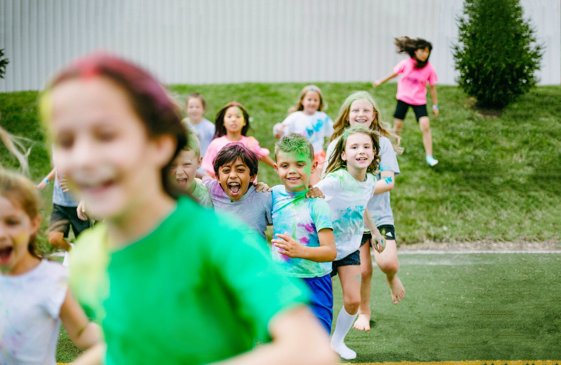 A group of children are running on a field.