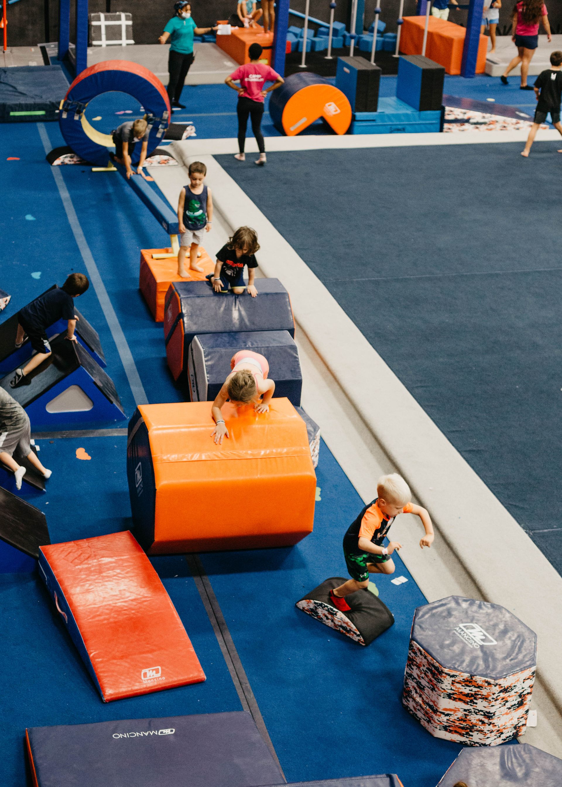 A group of children are playing in a gym