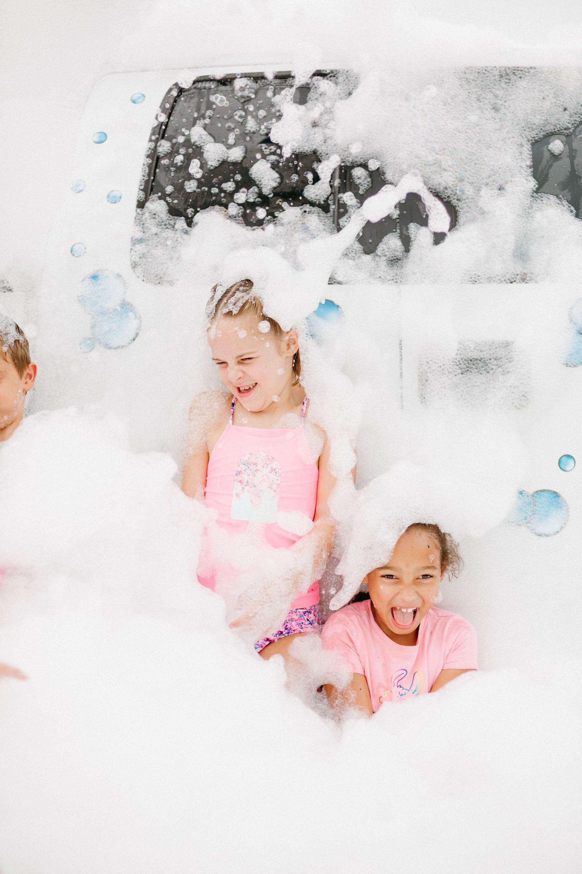 Children playing in a large amount of bubble foam.