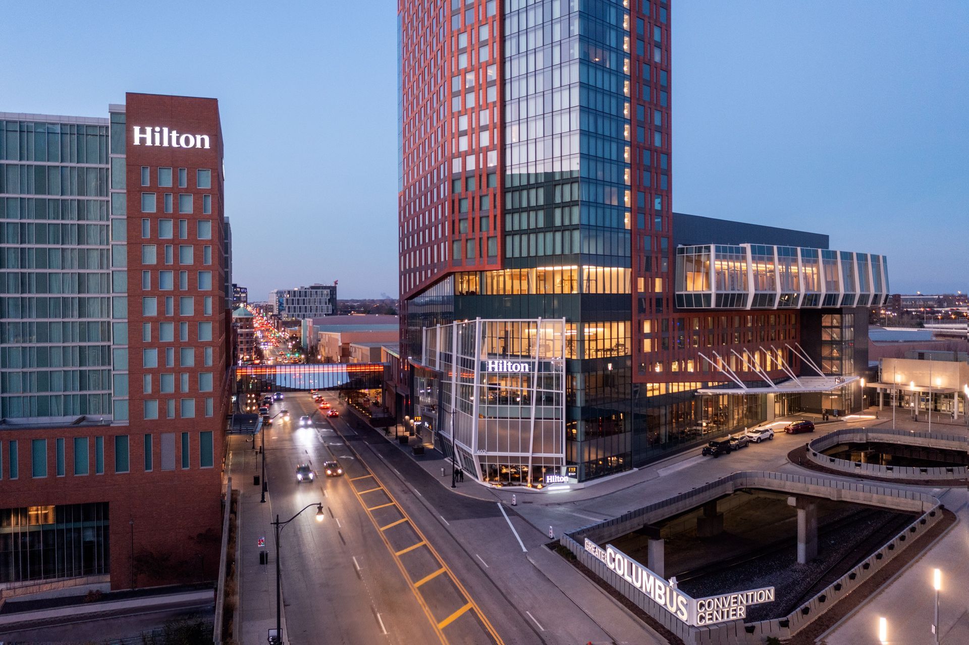 A large hotel with a glass canopy over the entrance.
