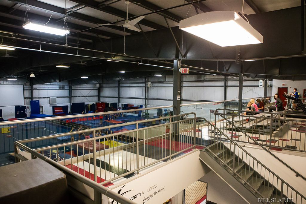 A large building with stairs leading up to the second floor