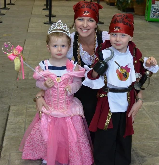 A Family in costumes, dressed up as pirates and princesses