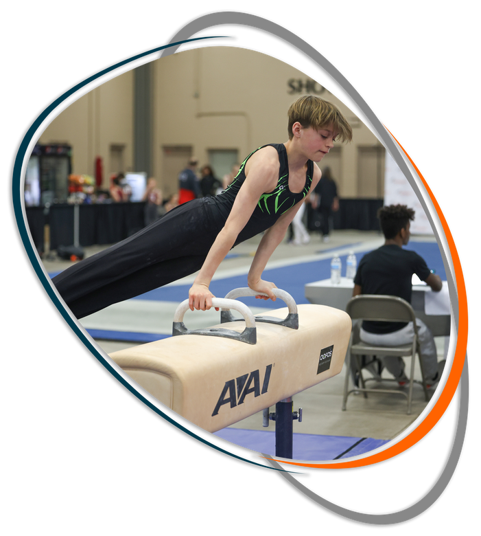 A young boy is doing a handstand on a pommel horse
