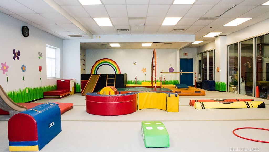 A large gym with a rainbow on the wall