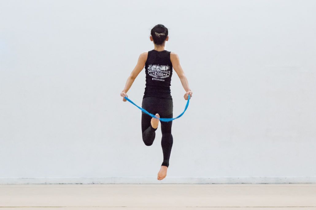 A person is jumping a jump rope in the air.