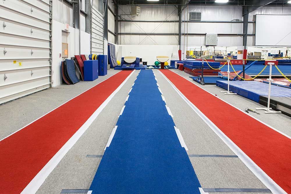 A gym with red white and blue lines on the floor