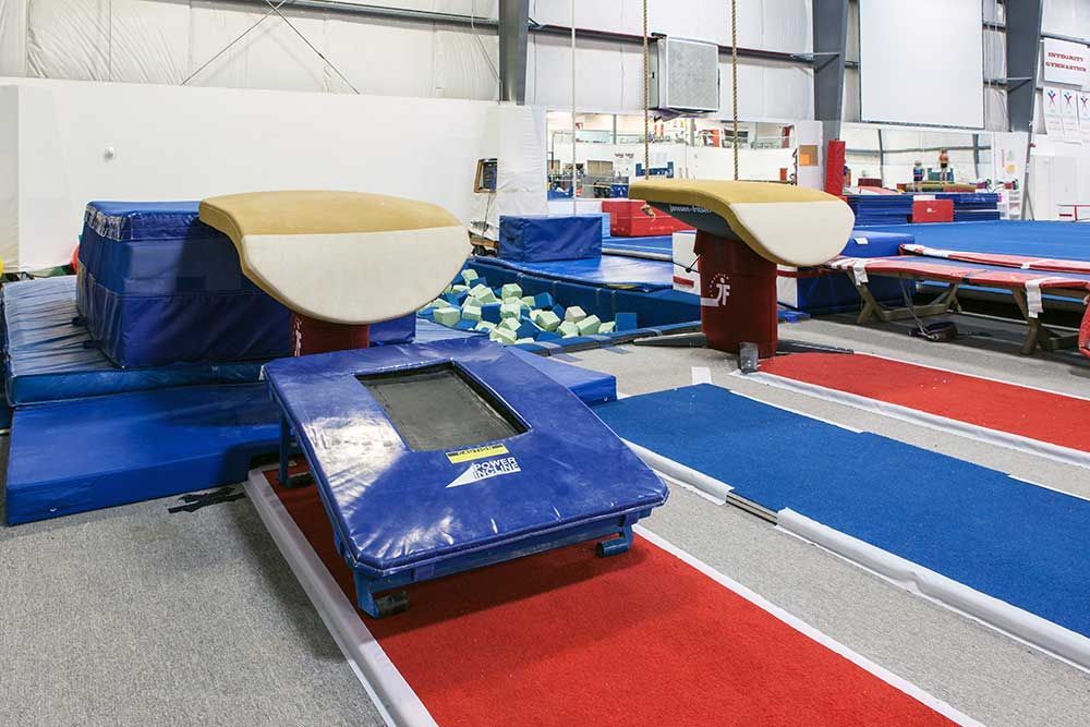A gym with a trampoline in the middle of it