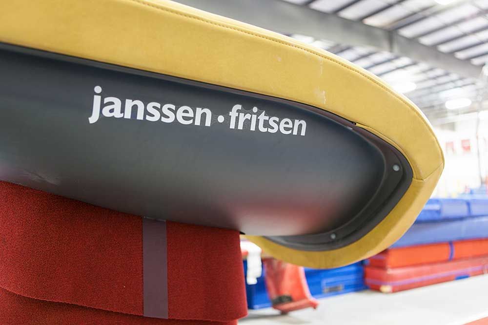 A janssen fritsen logo is on the back of a chair