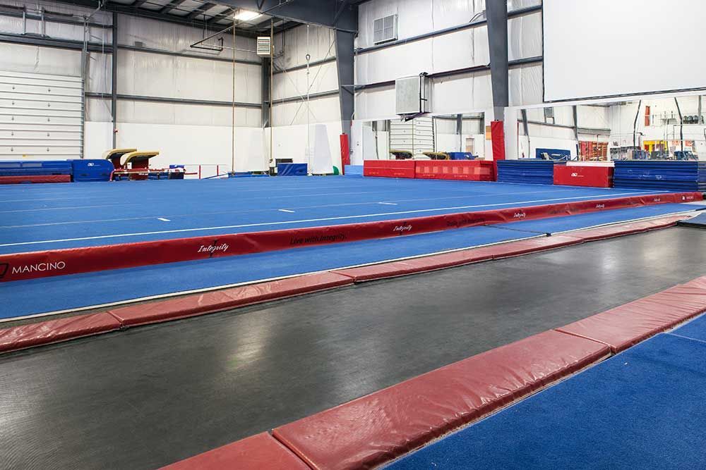 There is a trampoline in the middle of the gym.