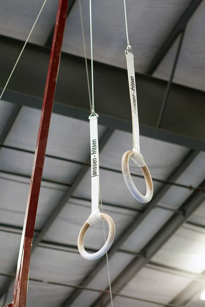 A pair of gymnast rings hanging from the ceiling