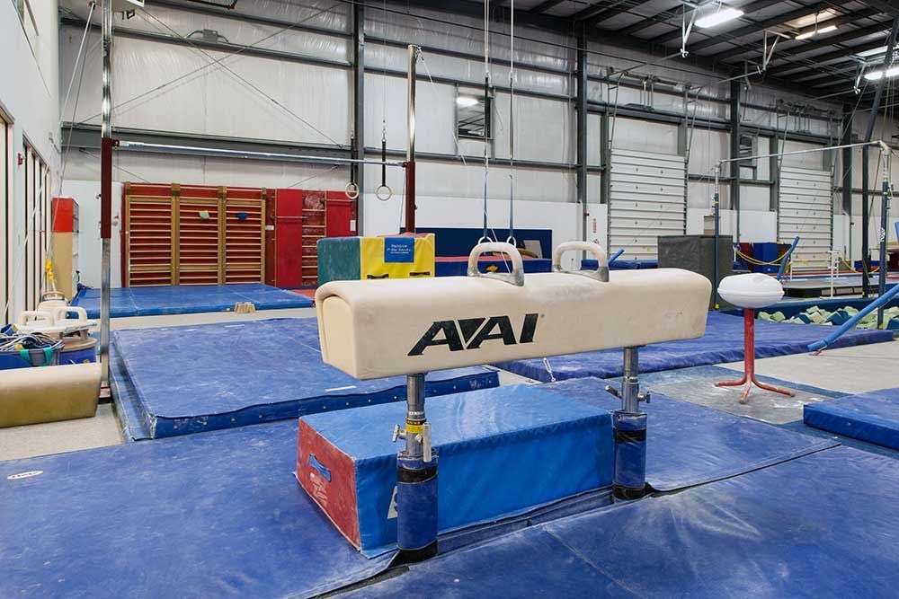 A gym with a balance beam that says avai on it.