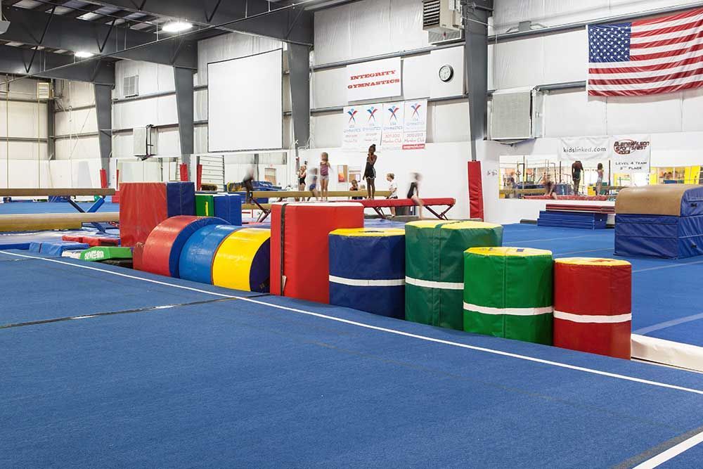 A gym with a row of colorful foam blocks on the floor.