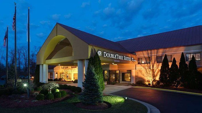 A large hotel with a purple roof is lit up at night.
