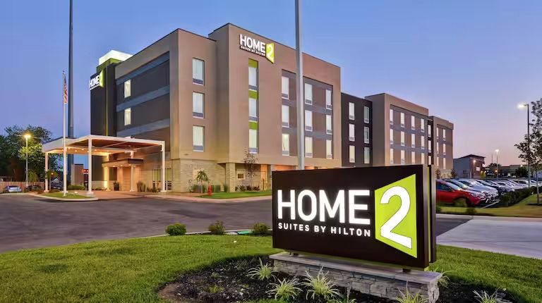 A large building with a sign in front of it that says home 2.