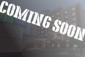 A sign that says coming soon in front of a building