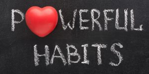 A blackboard with the words powerful habits written on it