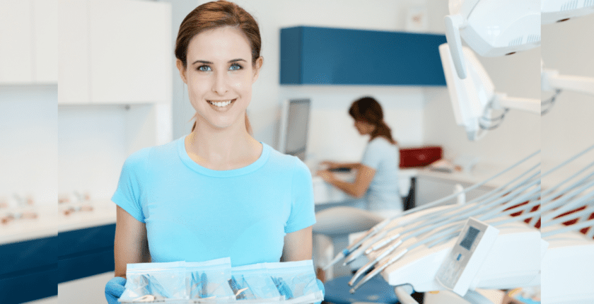 A woman is holding a tray of dental instruments in a dental office.