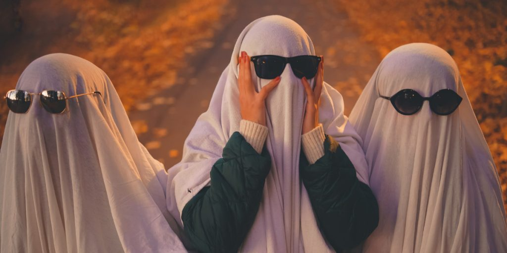 Three ghosts wearing sunglasses are standing next to each other.