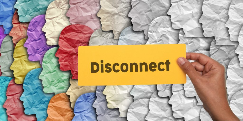 A person is holding a card that says `` disconnect '' in front of a group of people.