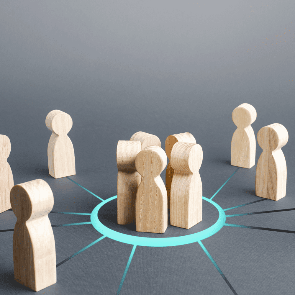 A group of wooden people are sitting in a circle