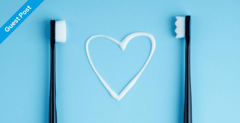 Two toothbrushes with toothpaste in the shape of a heart