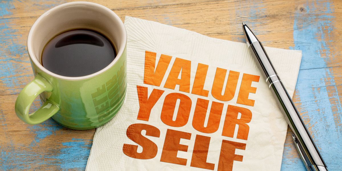 A napkin with the words `` value your self '' written on it next to a cup of coffee and a pen.