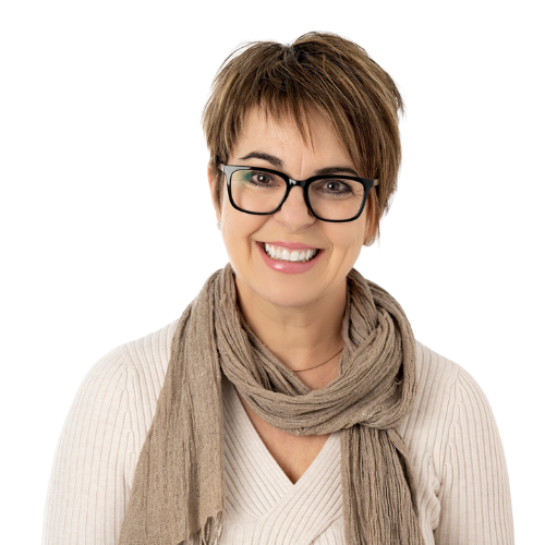 A woman wearing glasses and a scarf is smiling for the camera