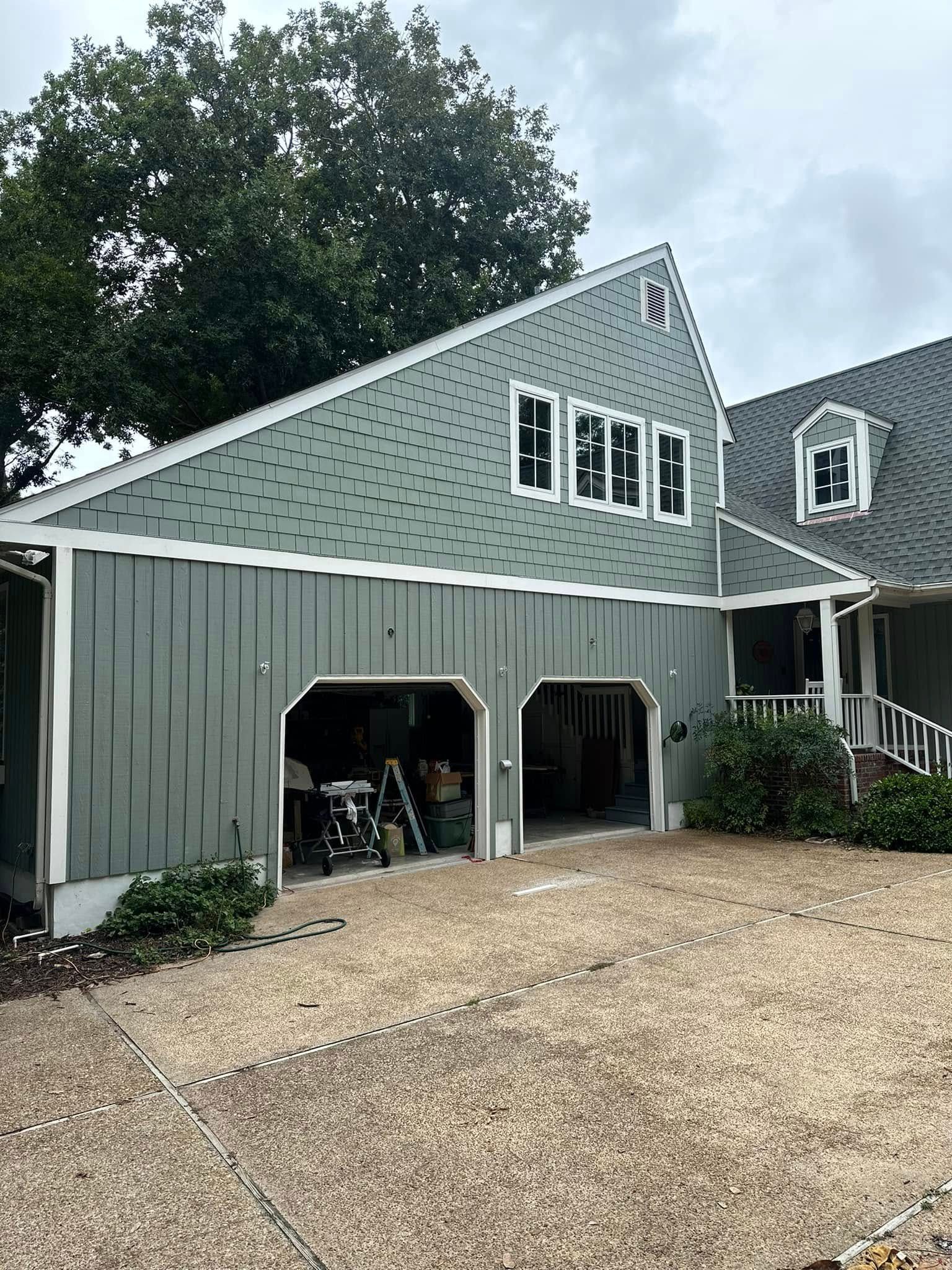 A large house with a garage and a driveway in front of it.