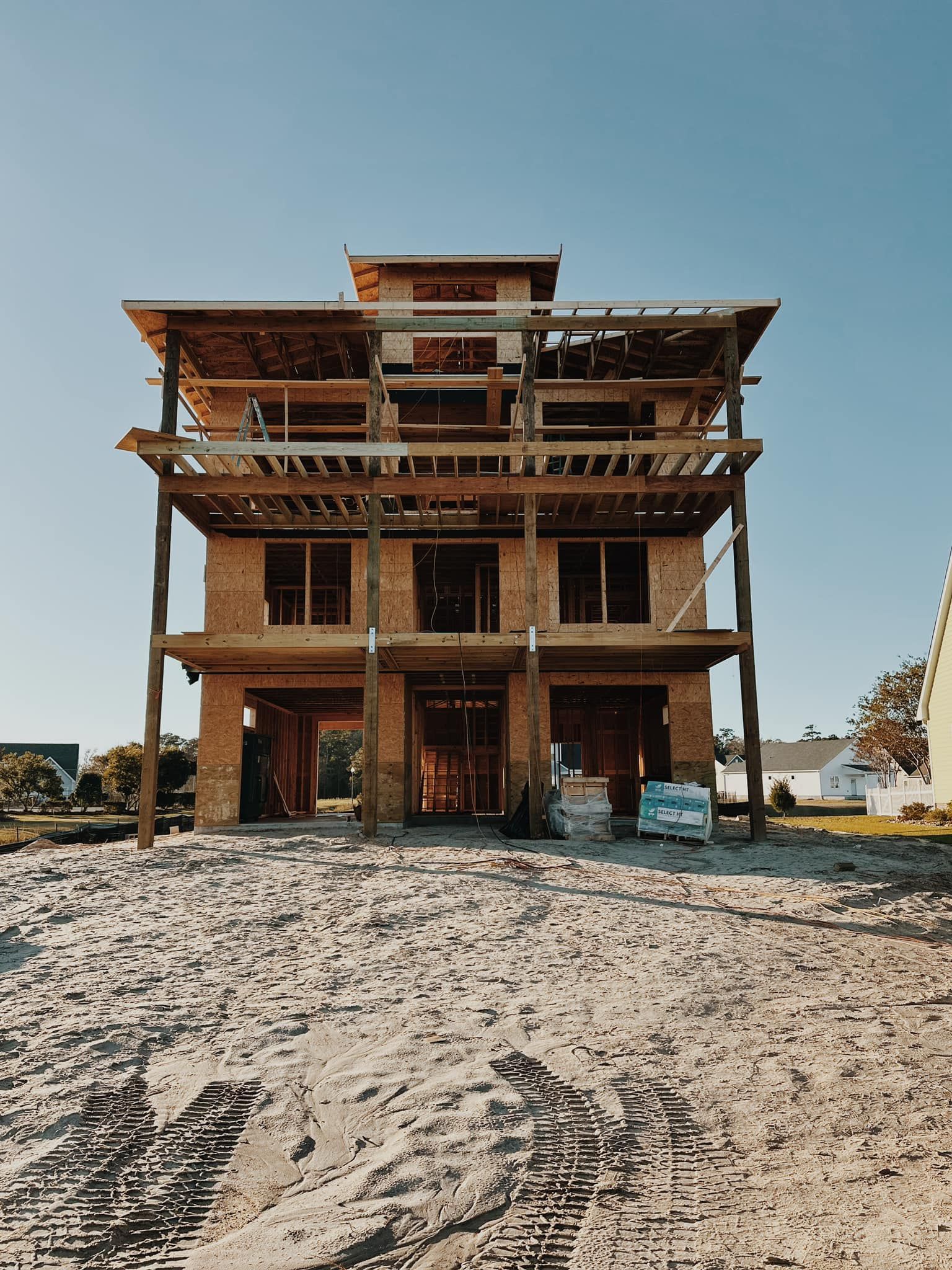 A large house is being built on the beach.