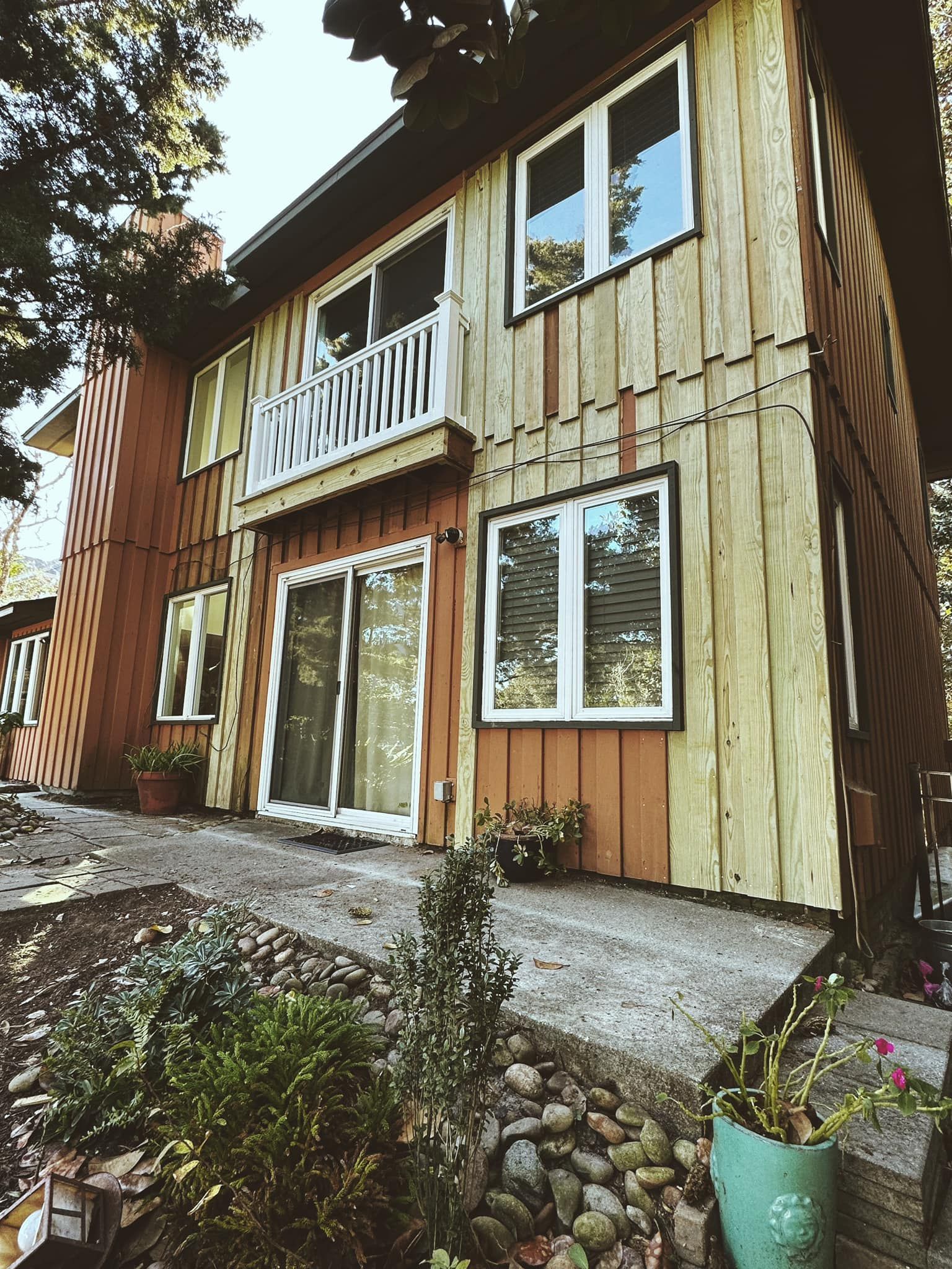 A large wooden house with a lot of windows and a balcony.