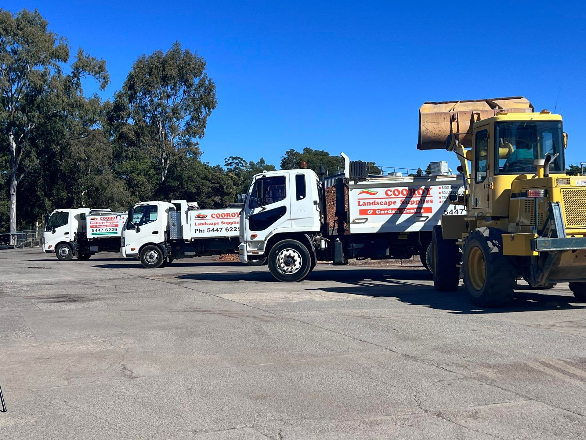 Three Trucks and a Loader Parked On The Road — Cooroy Landscape Supplies and Garden Centre in Cooroy, QLD